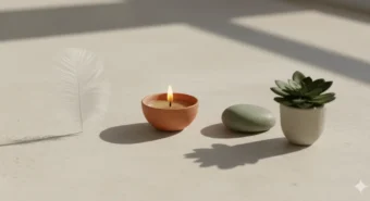 Os três doshas da ayurveda representados por uma pena, uma vela, uma pedra e uma planta em harmonia.